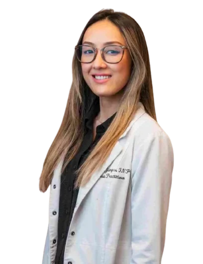 Close-up of Abbeygail Jiongco, FNP, focused while conducting a patient check-up with a stethoscope.