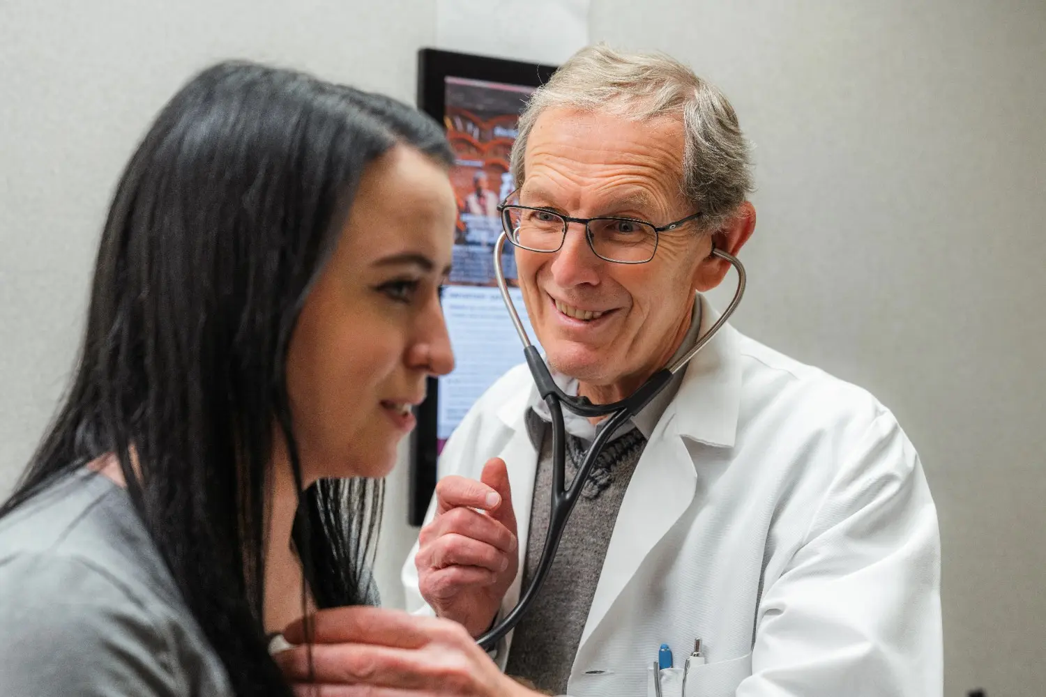Dr. Gavrilyuk engaged in a serious medical consultation with a patient in a clinical setting.
