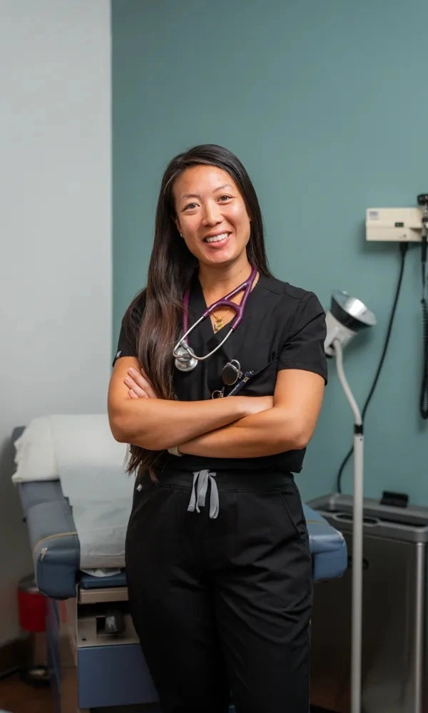 Krystal Lin, PA, focused on a patient consultation during a primary care appointment.