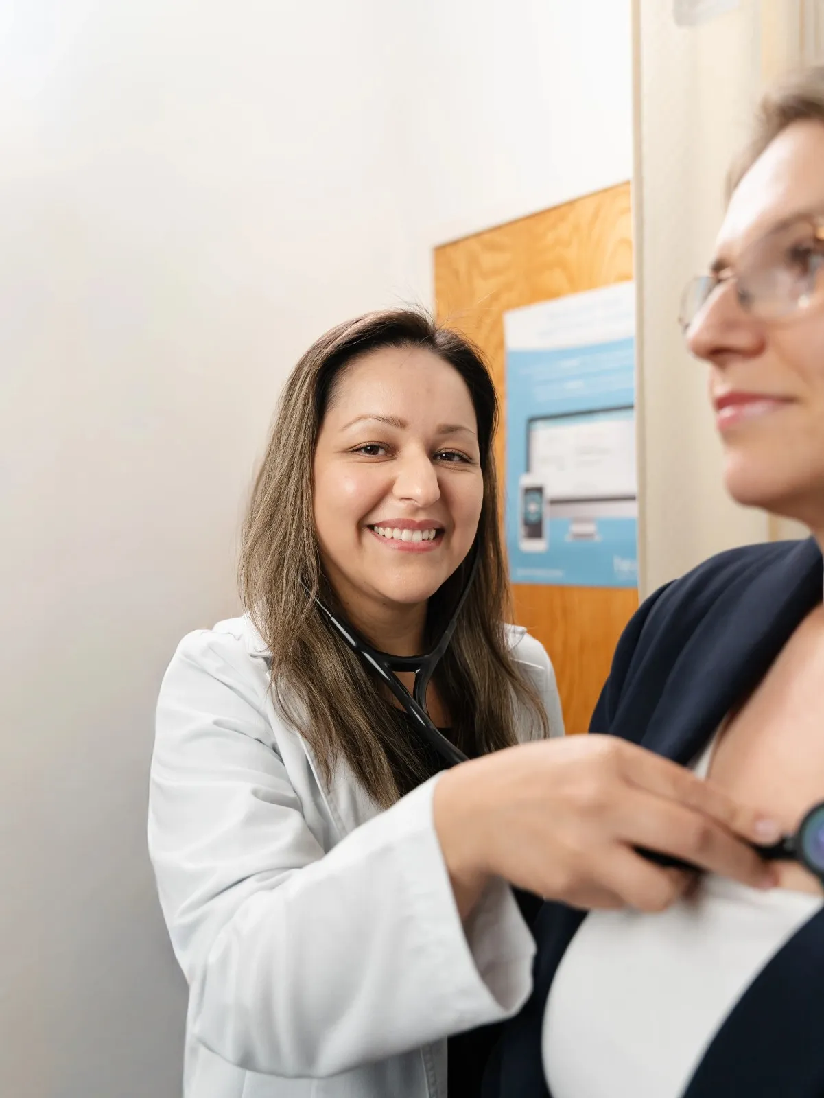 Dr. Raylina Morris interacting warmly with a patient during a clinical consultation.