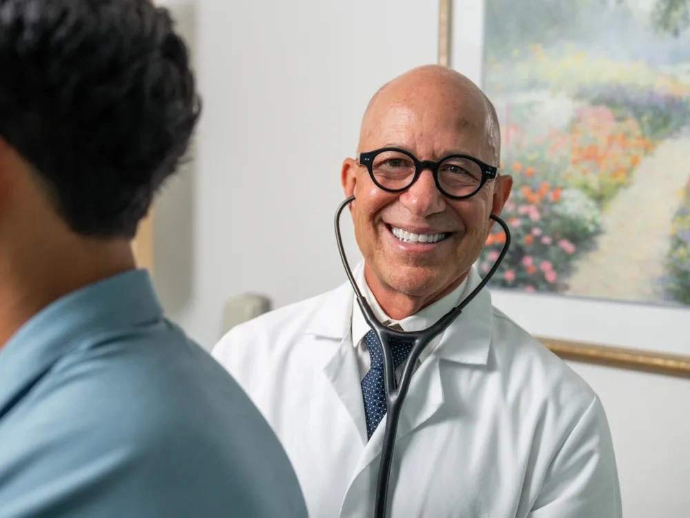 Dr. William Padilla listening attentively to a patient's concerns during a medical appointment.