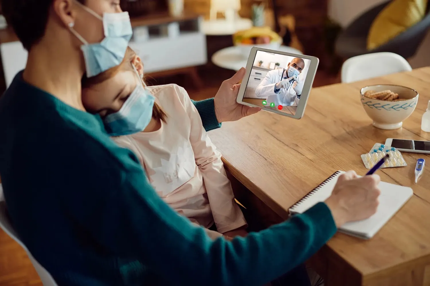 mother holding her child during a virtual doctor's appointment on a tablet